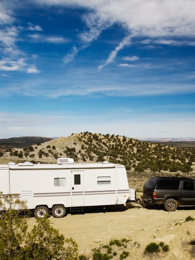53788-car-pulling-trailer-in-desert-landscape-gra-2026-03-25-05-13-23-utc.